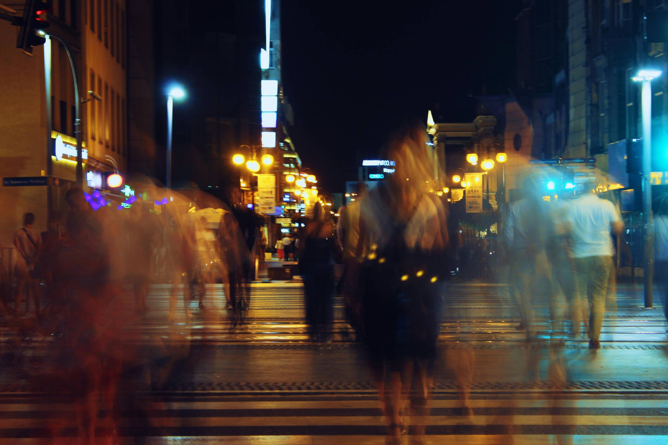People walking at night in a city
